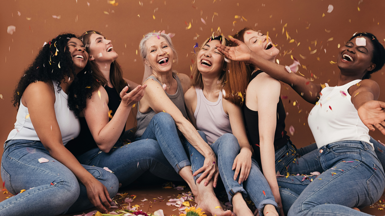 International Women’s Day blog image featuring diverse women laughing together, symbolizing empowerment, self-care, intimacy wellness, and emotional connection.