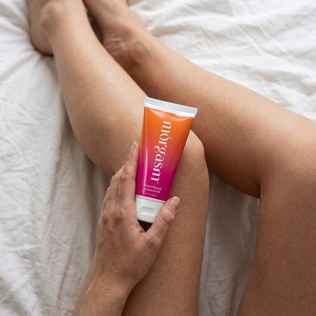 Holding the Original Arousal Gel tube in bed