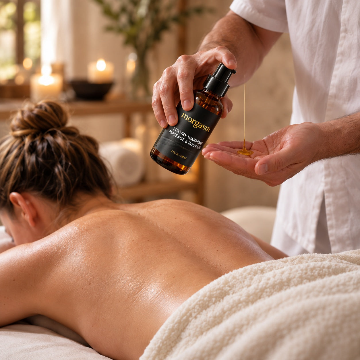 Pouring the warming oil during a back massage