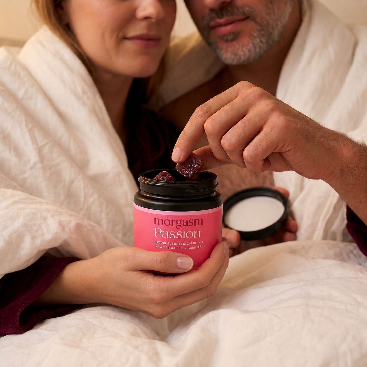 Couple in bed taking a Passion gummy